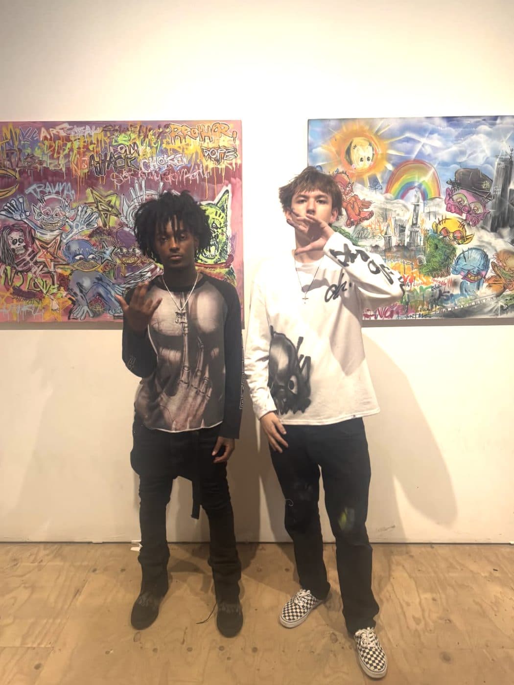 Hemsley and a guest in front of his paintings in the gallery